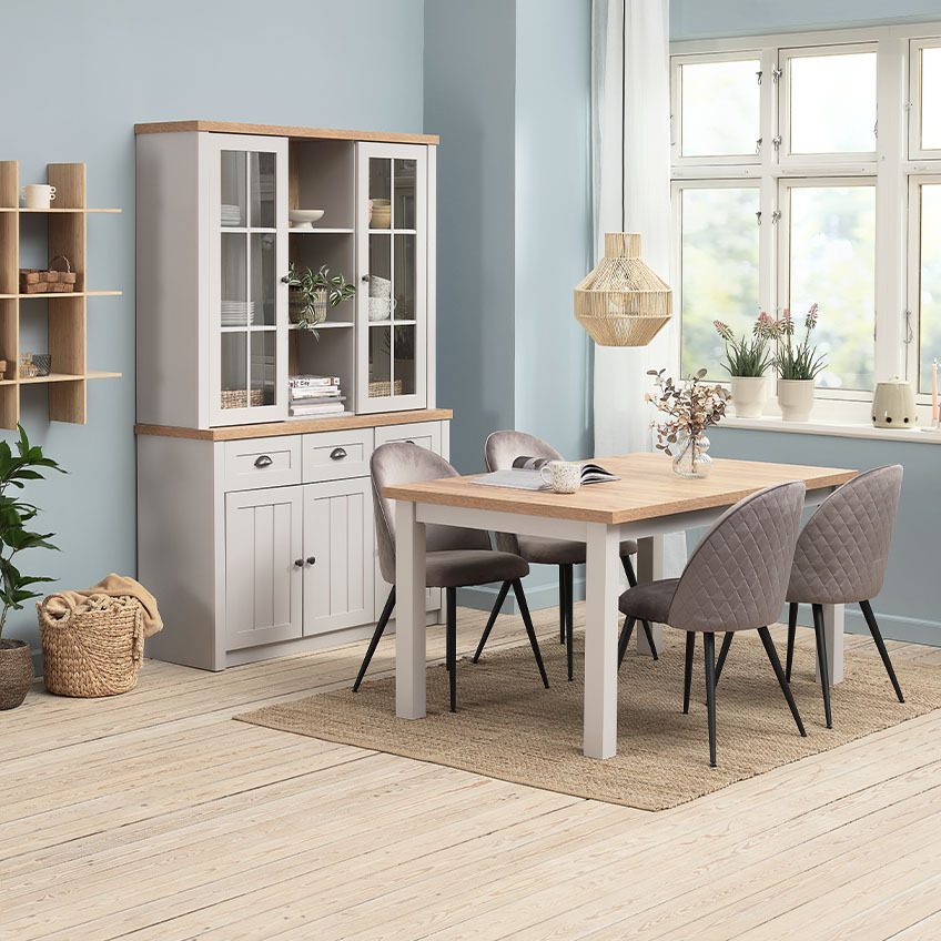 Storage furniture such as sideboard with upper cabinets and a matching dining table in dining room 