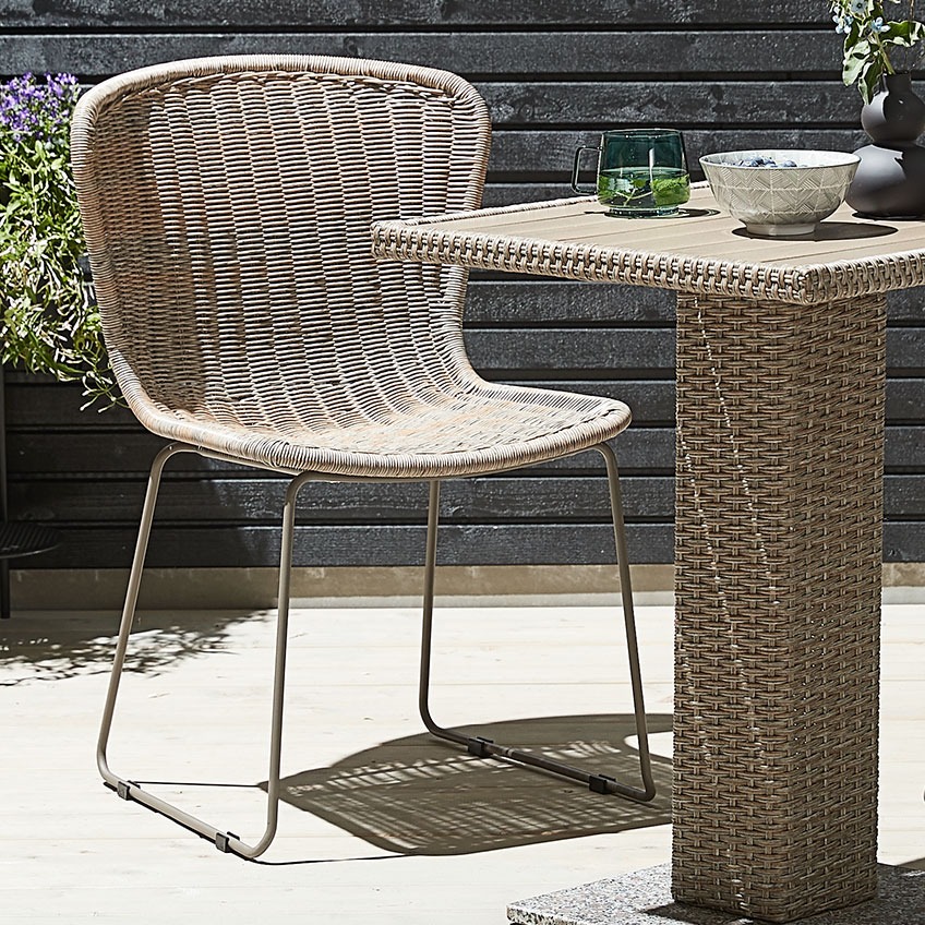 Vrtna stolica prirodnog izgleda, izrađena od petana i metala s bistro stolom od petana na terasi
