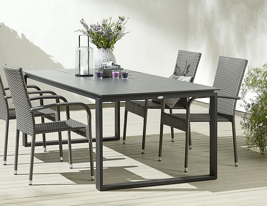 Black garden table with garden chairs on a patio
